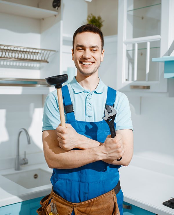 cheerful male plumber holds wrench and plunger 2021 08 28 02 49 30 JXEAURY